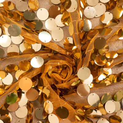 Gold sequin fabric with circular sequins arranged in a spiral pattern.