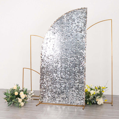 Sequin backdrop with gold frame and floral arrangements in a studio setting.