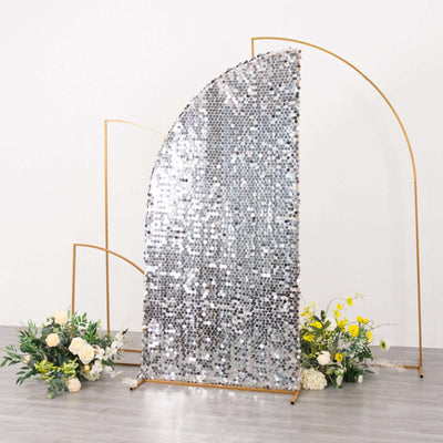 Silver sequined backdrop with gold frame and floral arrangements.