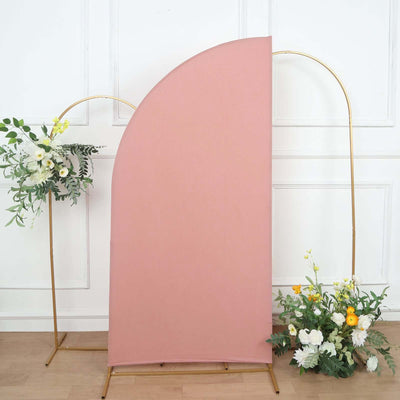 Pink backdrop with gold stands and floral arrangements on either side.