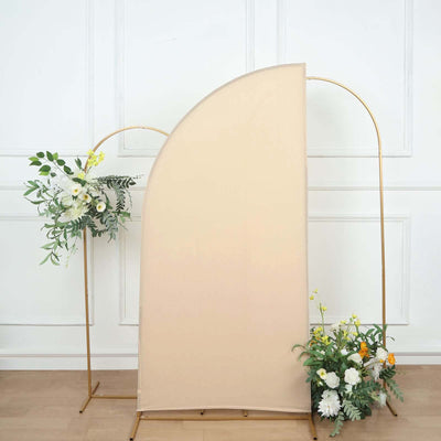 Neutral fabric backdrop with floral arrangements on a gold frame.