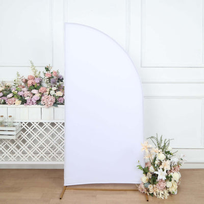 White curved backdrop with floral arrangement in a studio setting.