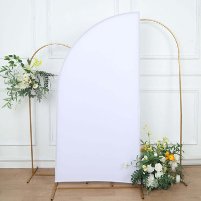 White backdrop with floral arrangements on gold stands.