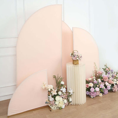 Pastel backdrop with flowers and a decorative table.