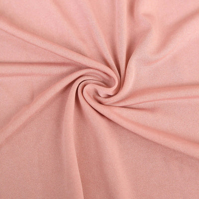 Peach-colored fabric with a smooth, textured surface.