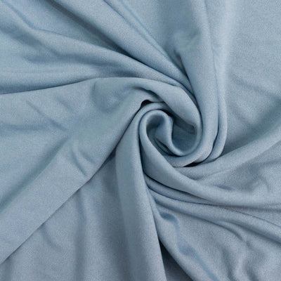 Light blue fabric draped in a spiral pattern.