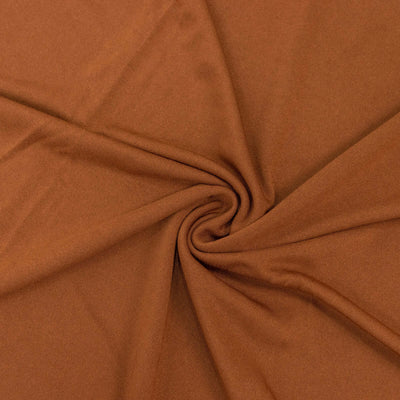 Brown fabric with a smooth texture in a swirling pattern.