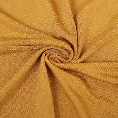 Textured mustard fabric in a swirl pattern for design inspiration.