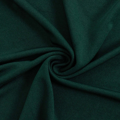 Dark green fabric with a soft texture, elegantly swirling in a circular pattern.