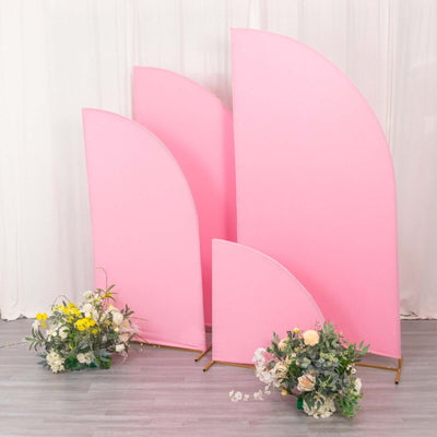 Pink backdrop panels with floral arrangements in front.