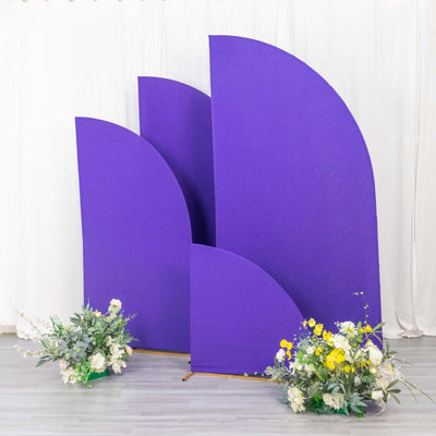 Purple geometric backdrop with floral arrangements in front.