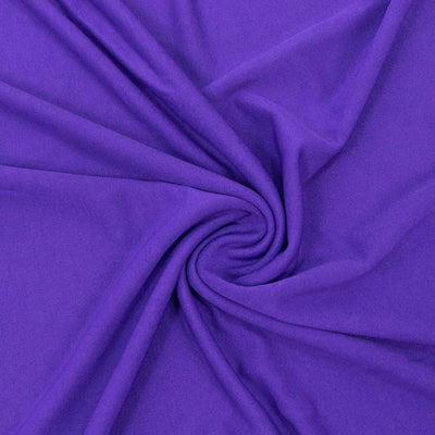 Purple fabric texture swirling in a circular pattern.