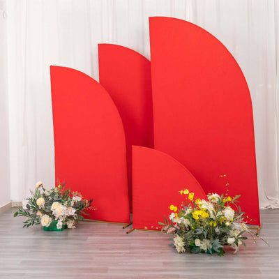 Red curved backdrops with floral arrangements in a studio setting.