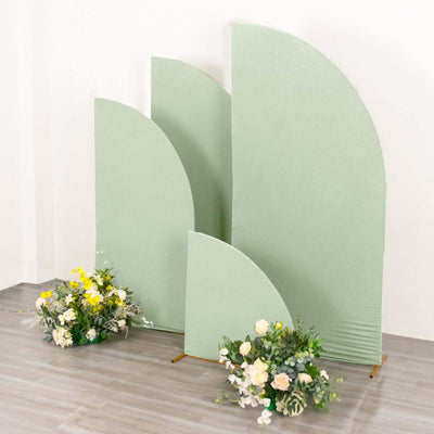 Green curved backdrop panels with floral arrangements in front.