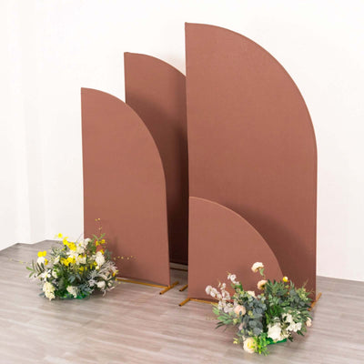 Brown curved partition stands with flowers in a studio setting.