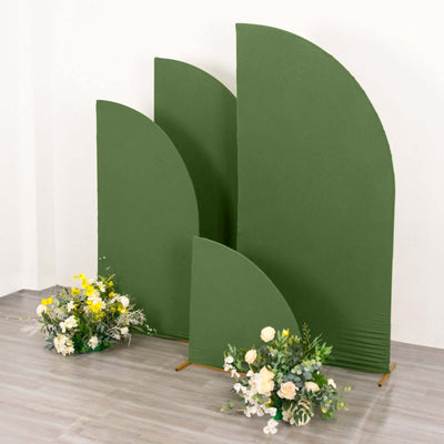 Green curved backdrops with floral arrangements in front.