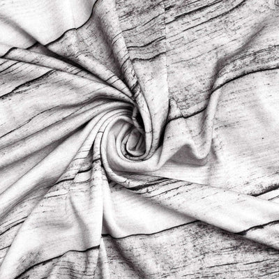 Close-up of textured fabric with a wood grain pattern in black and white.