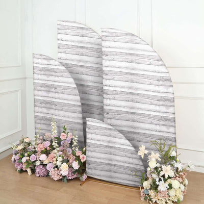 Decorative wooden backdrop with floral arrangements in front.