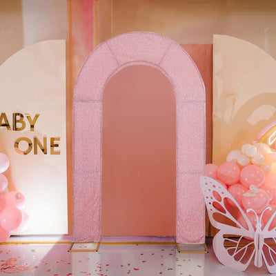 Pink glitter arch for baby shower decoration with balloons and butterfly accents.