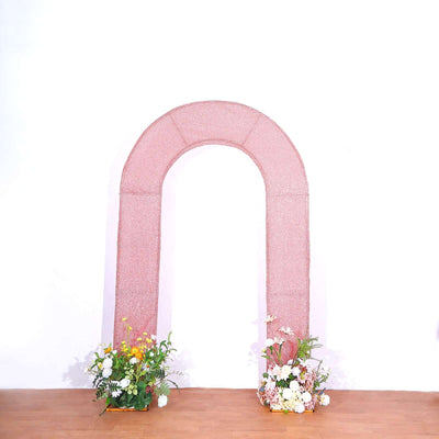 Pink arch with floral arrangements on both sides