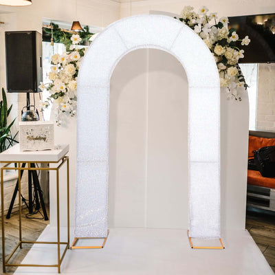 Sparkling wedding arch with floral accents on a studio backdrop