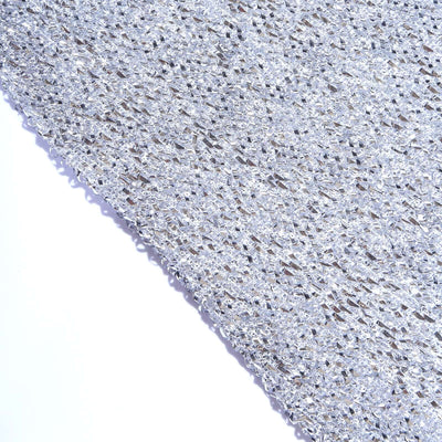 Silver textured fabric sheet on a plain background.