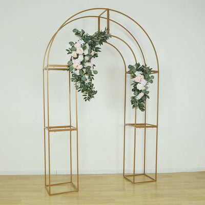Gold wedding arch with floral decorations and greenery for event decor.