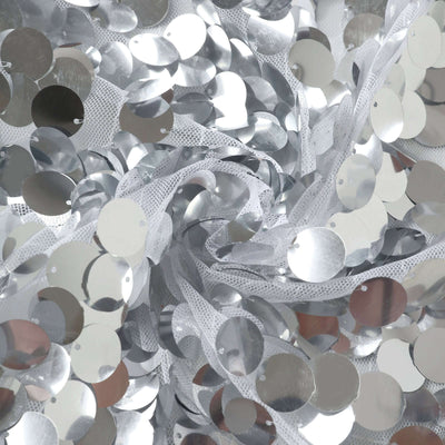 Silver sequin fabric with shiny circular embellishments.