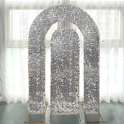 Decorative archway with shimmering sequins on a gold frame against a light background.