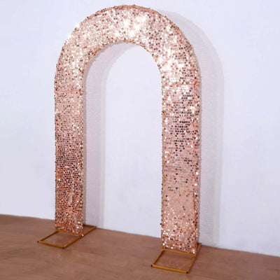 Rose gold sequin archway decoration for events and celebrations.