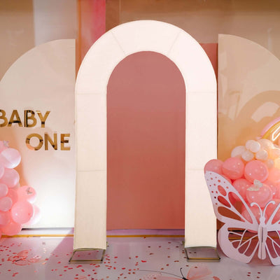 Illuminated arch decoration for a baby-themed event setup.