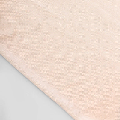 Soft peach fabric texture on a light gray background.