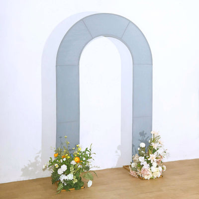 Gray arch backdrop with floral arrangements on either side.