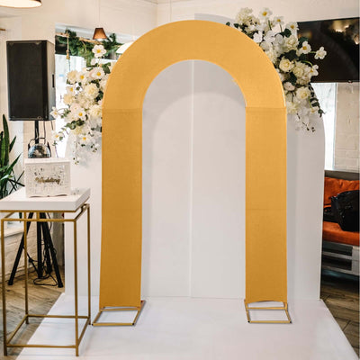 Gold arch backdrop for events with floral decorations.