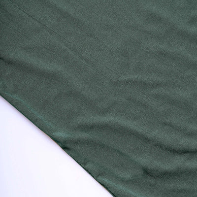 Green textured fabric on a plain background.