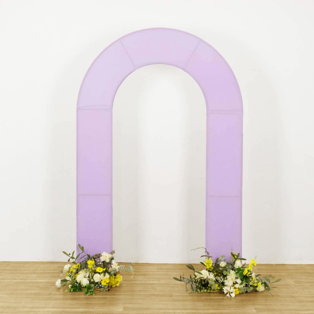 Purple arch with floral arrangements at the base on a plain backdrop.