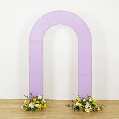 Purple arch with floral arrangements at the base on a plain backdrop.