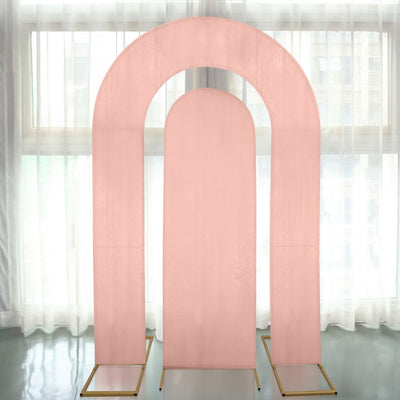 Pink arch backdrop display with gold stands for events and photography.