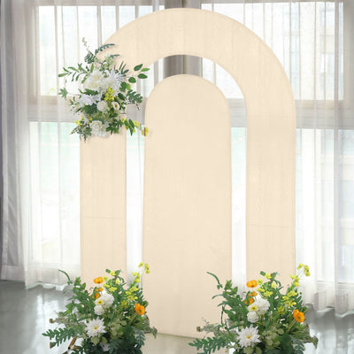 Decorative arch backdrop with flowers and greenery for events or photography.