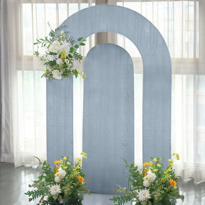 Decorative arch backdrop with floral arrangements for events.