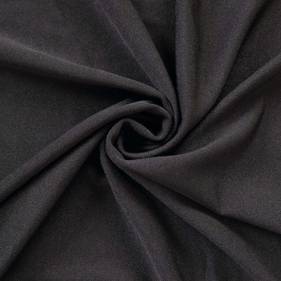 Black fabric texture in a spiral fold, showcasing soft material details.