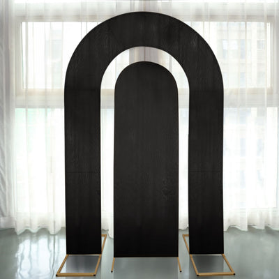 Black arch backdrop stands against a light, airy window.