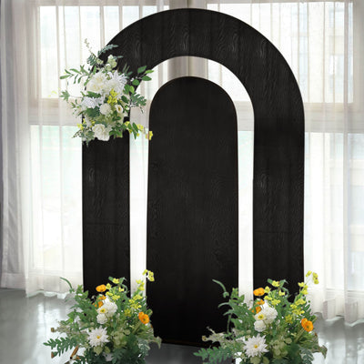 Black arch backdrop with floral arrangements for events and photography.