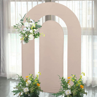 Decorative arch backdrop with floral arrangements for events and photography.