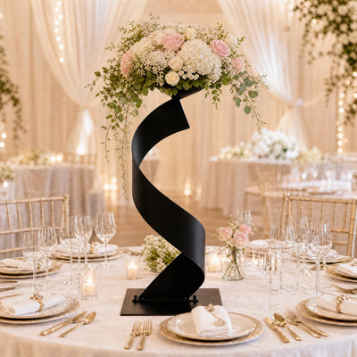 Elegant wedding table centerpiece with floral arrangement and gold place settings