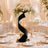Elegant wedding table centerpiece with floral arrangement and gold place settings