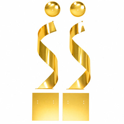 Golden metal wall sculpture with two spiral ribbon forms on white background