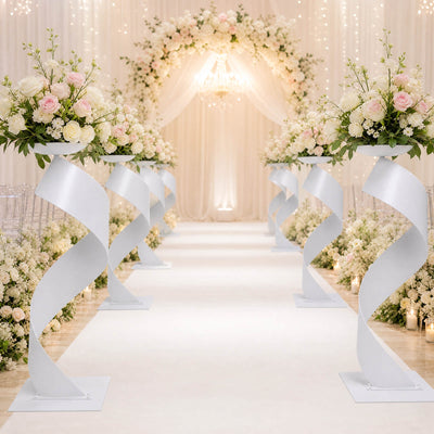 Elegant white and blush wedding aisle with floral arrangements and archway