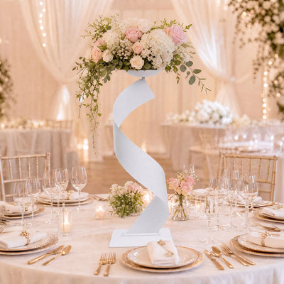 Elegant wedding table centerpiece with pastel flowers and gold table settings