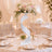 Elegant wedding table centerpiece with pastel flowers and gold table settings